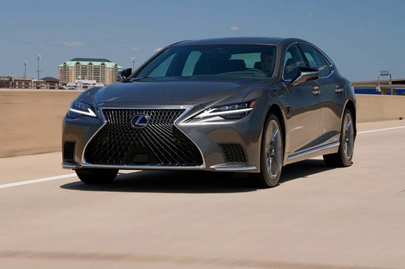 Photo of a Lexus car travelling during day time.